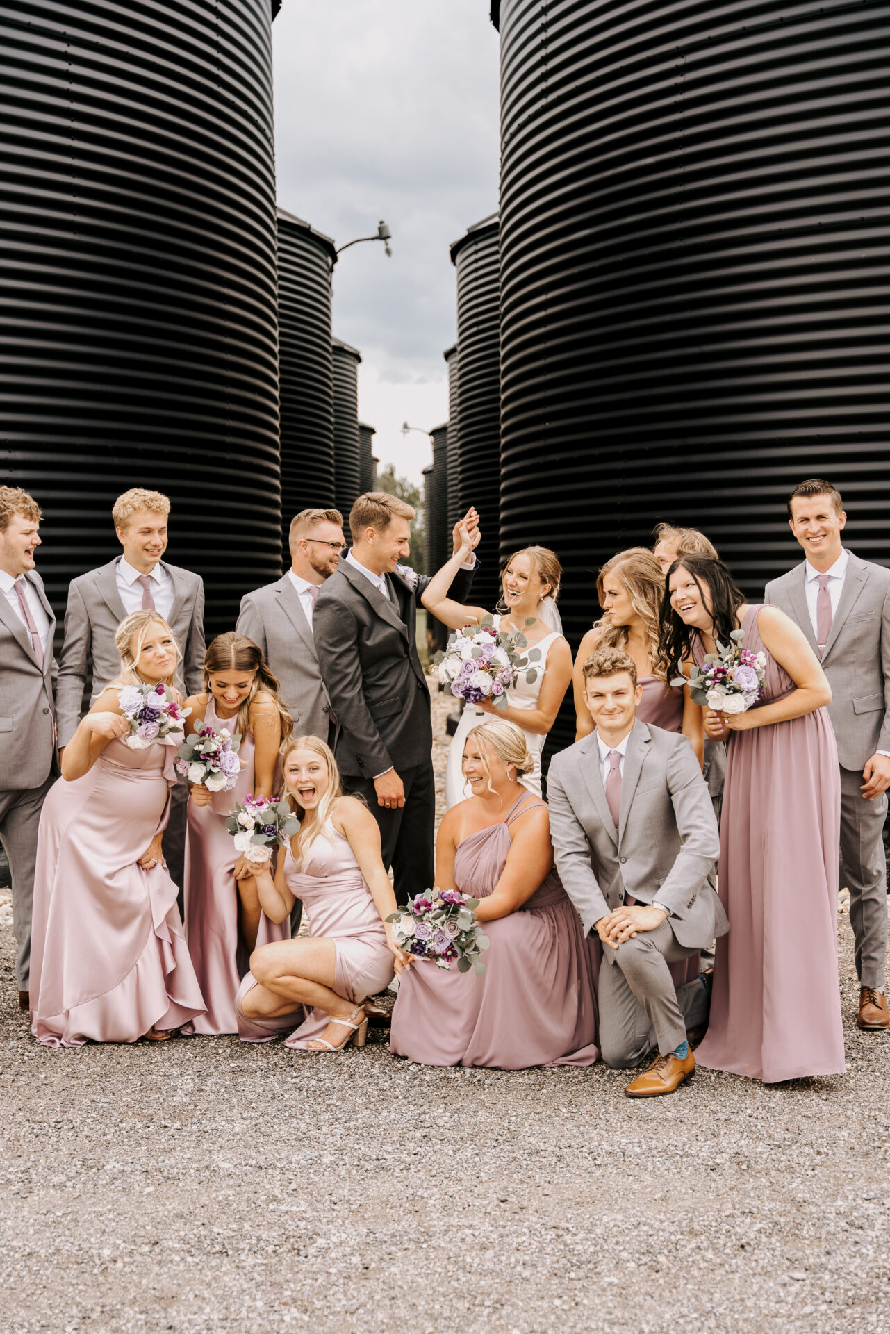 Bridal Party Photo with Purple Bridesmaid Dresses and Gray Groomsmen Suits