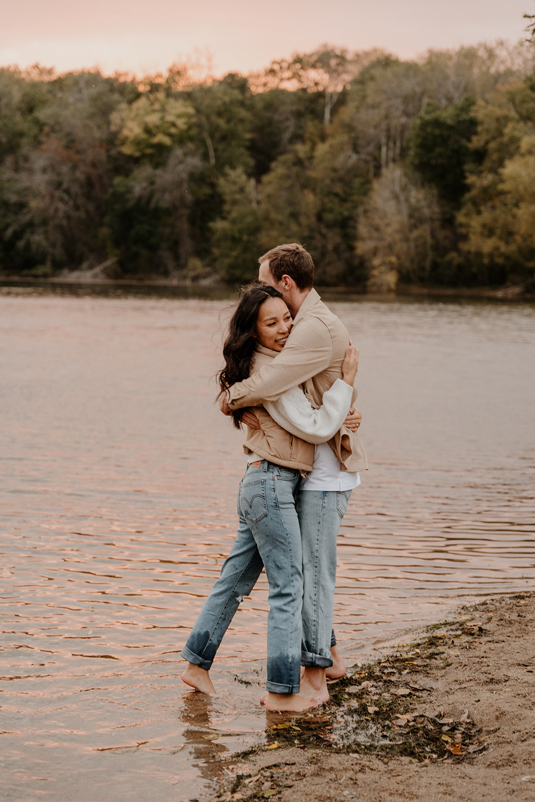 engaged couple hugging on the beach during photoshoot